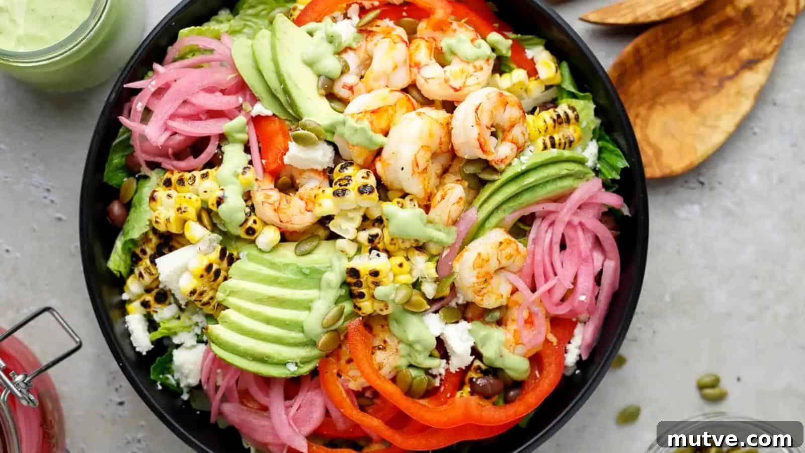 40 End-of-Summer Cookout Recipes to Celebrate Summer's Finale 26 A bowl of salad with grilled shrimp, avocado slices, grilled corn, pickled onions, black beans, tomato, lettuce, pepitas, and green dressing.