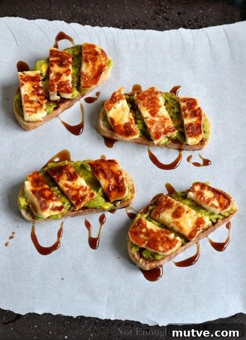 Grilled Halloumi and Avocado Tartine with Pomegranate Molasses 2 Grilled Halloumi, Avocado and Pomegranate Molasses Tartine served on parchment paper