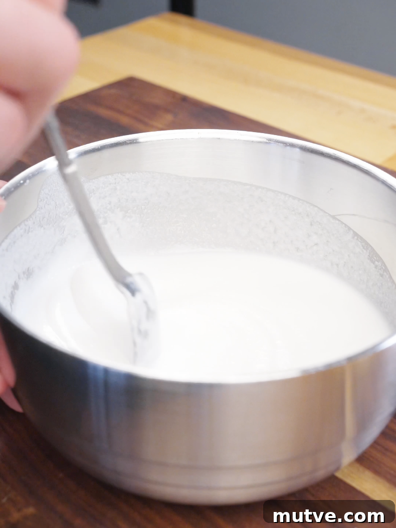 Bowl of rice flour and potato starch batter being mixed with water until smooth for the Honey Butter Fried Chicken Recipe.