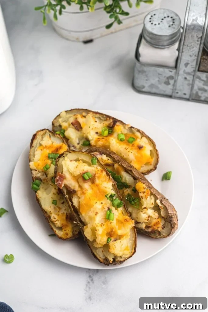 Air fryer twice baked potatoes stacked on a plate. 