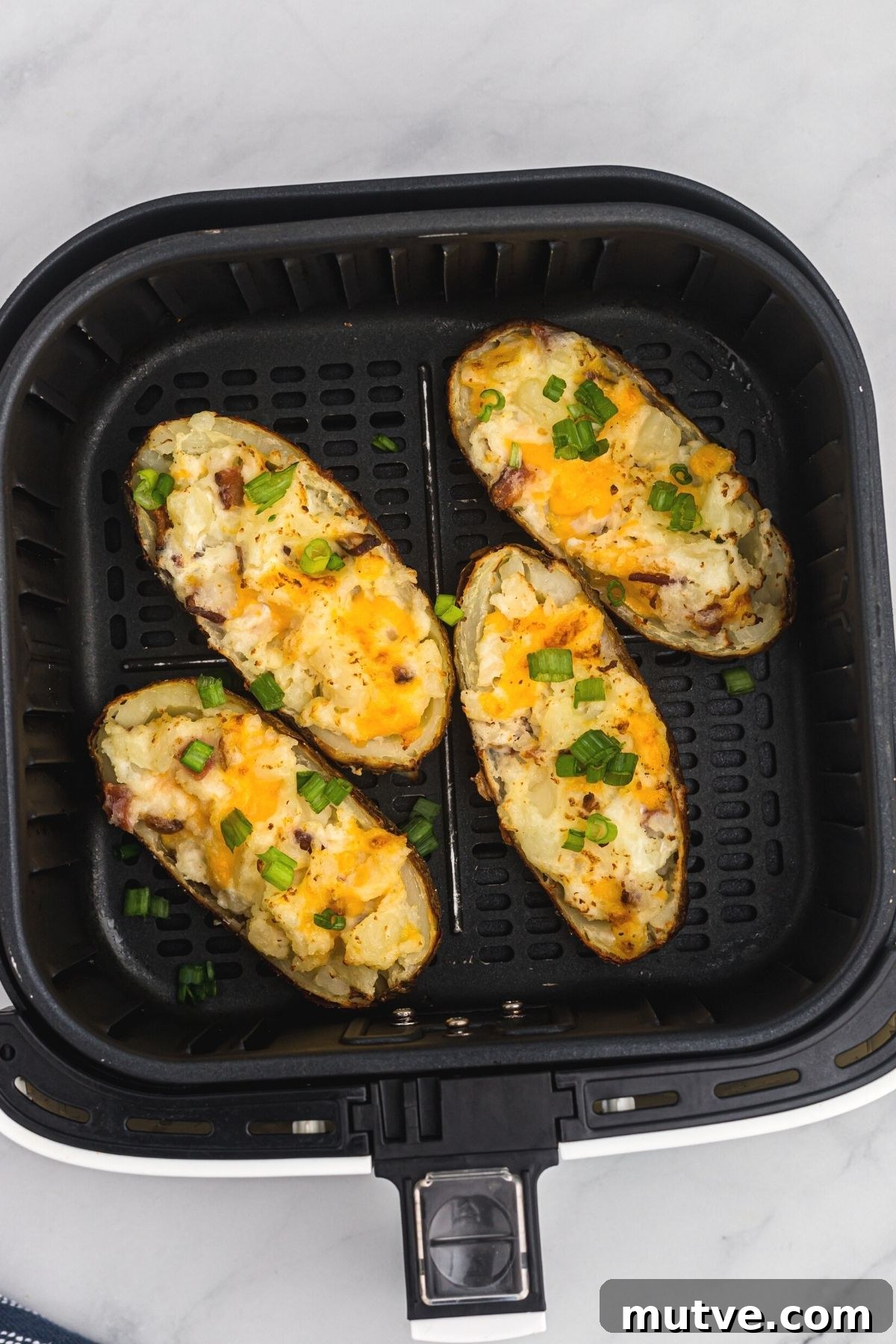 Twice baked air fryer potatoes topped with chopped green onion. 
