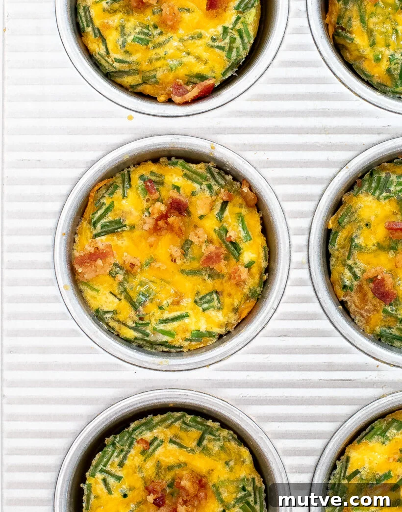 Bacon and Egg Breakfast Muffins Recipe 3 Bacon egg muffin cups in a silver muffin tin.