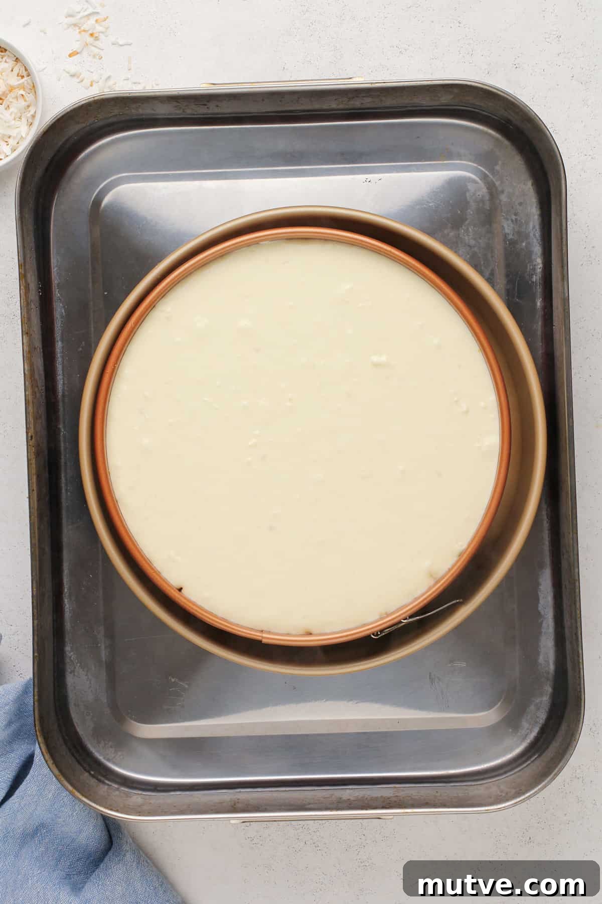 Creamy Coconut Cheesecake Recipe 11 Unbaked coconut cheesecake in a water bath.