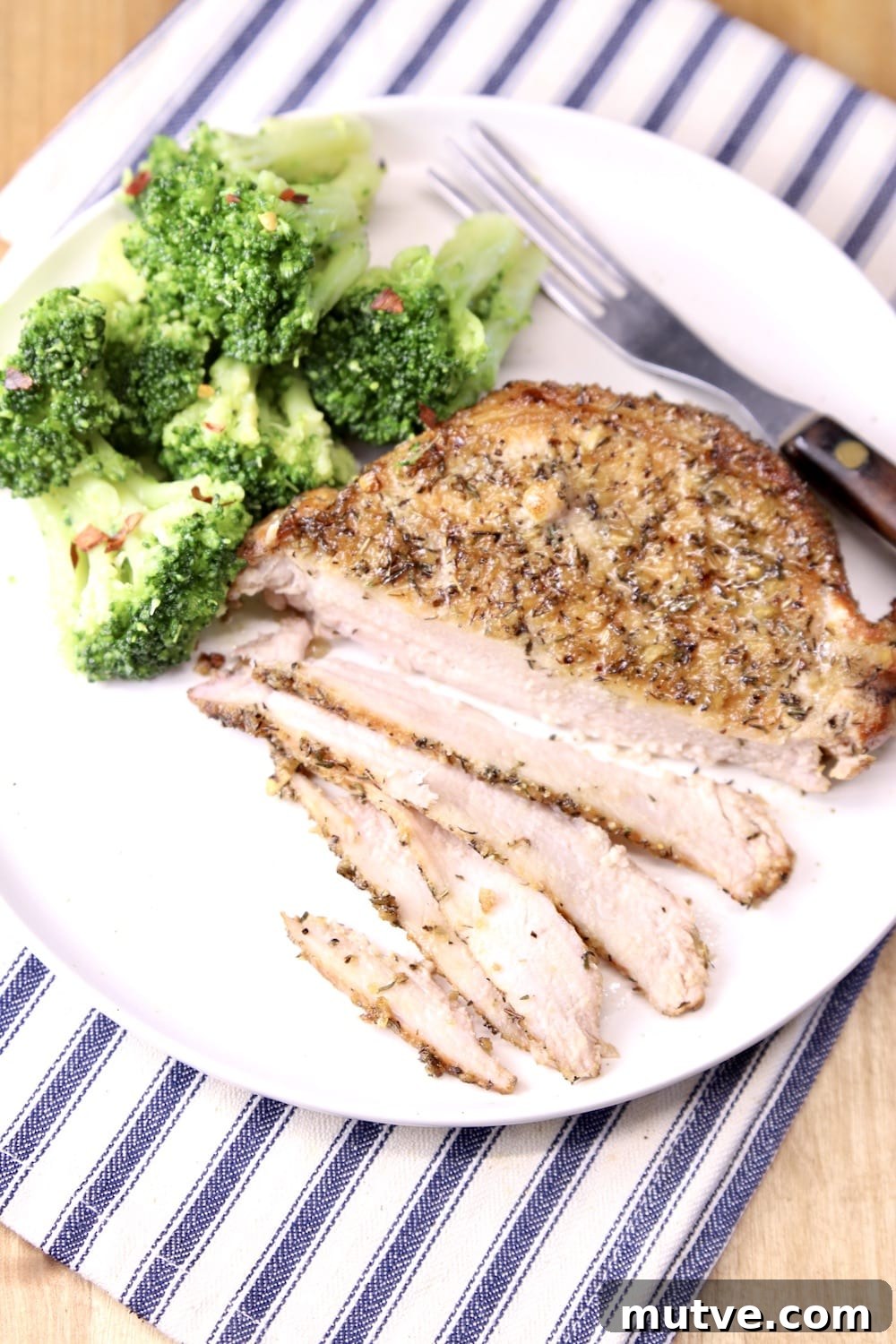 grilled pork chop on a plate with broccoli