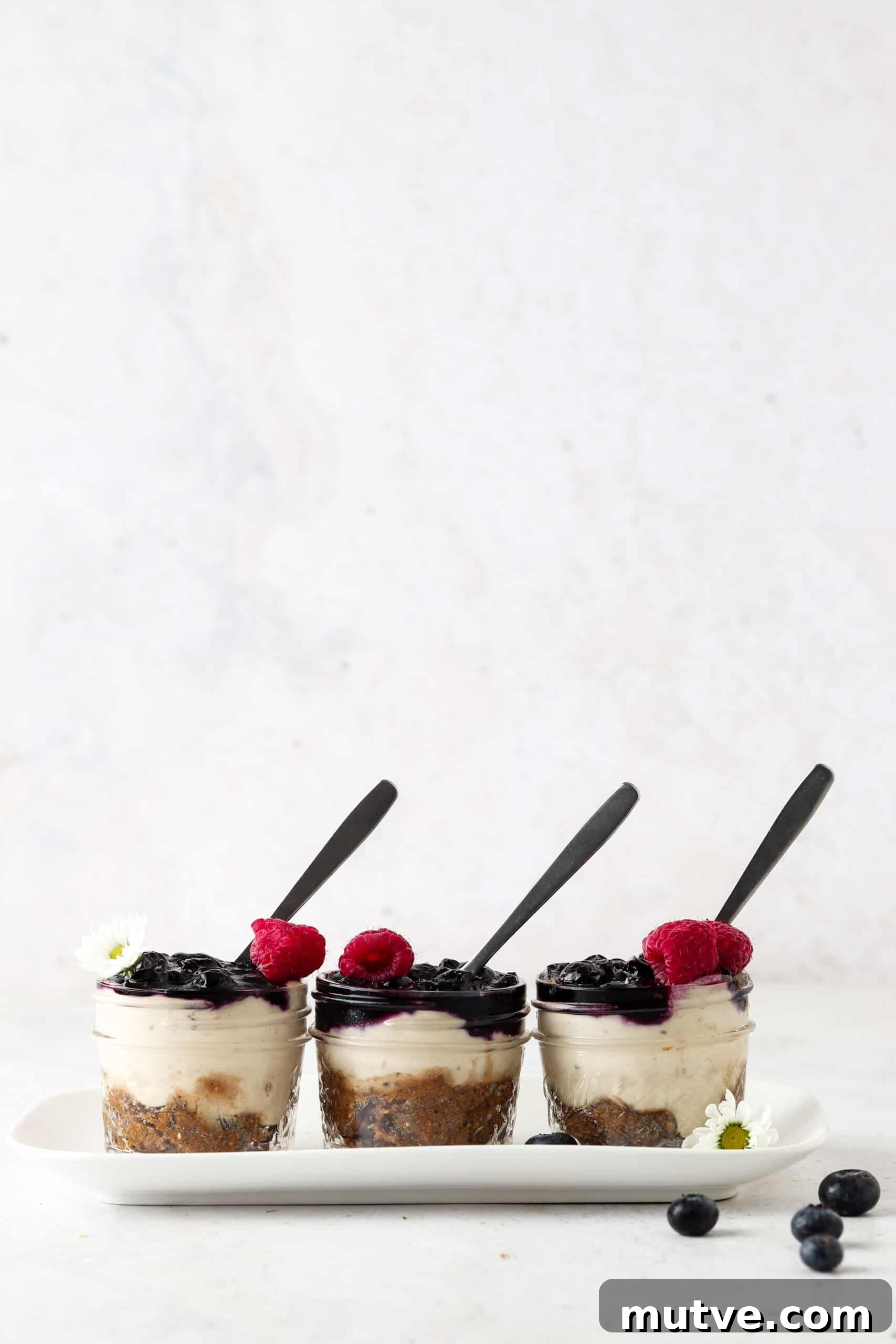 Vegan blueberry cheesecake jars on a tray. 