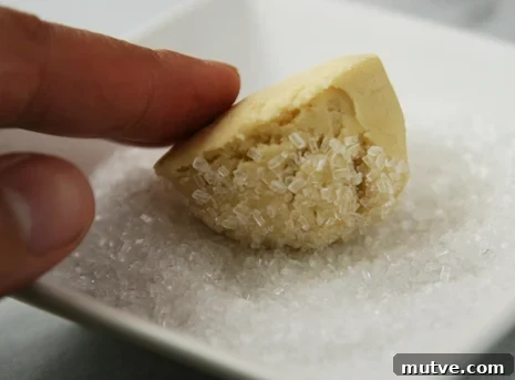 rolling cracked cookie rolling cookie in sugar