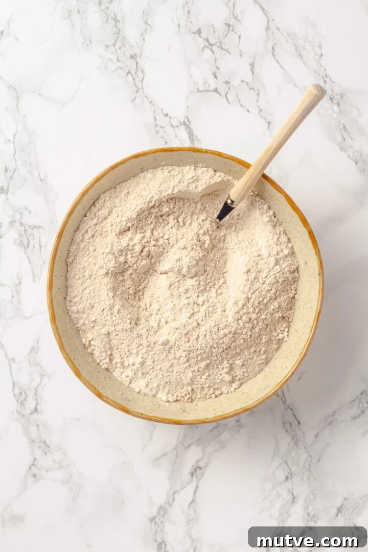 Overhead view of dry ingredients for protein pancakes in mixing bowl