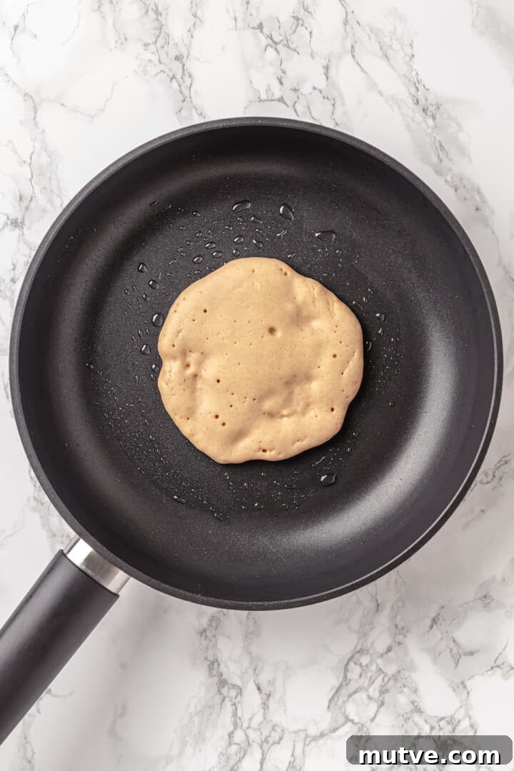 Overhead view of pancake in skillet before flipping