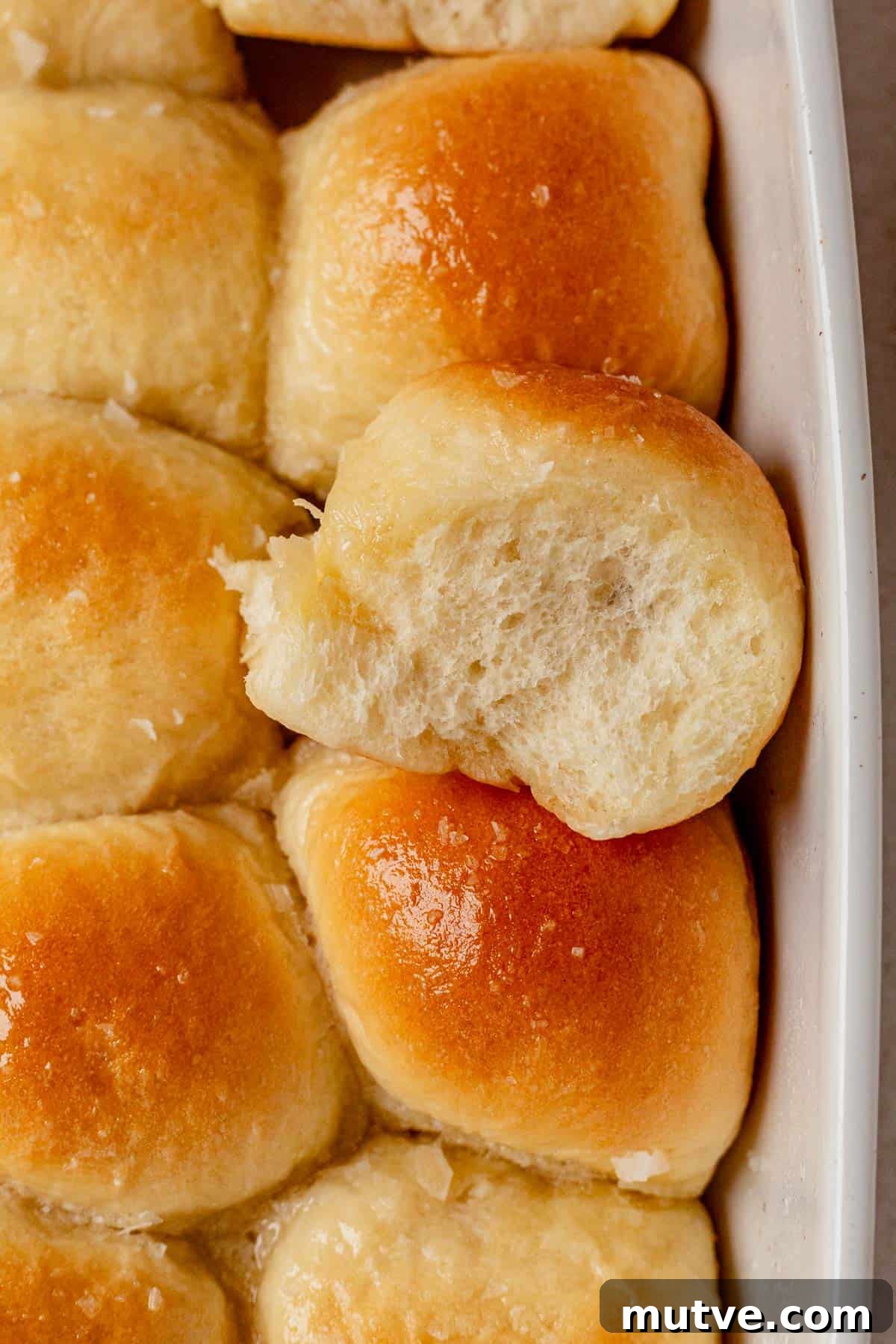 a cottage cheese dinner roll being pulled out of the pan.