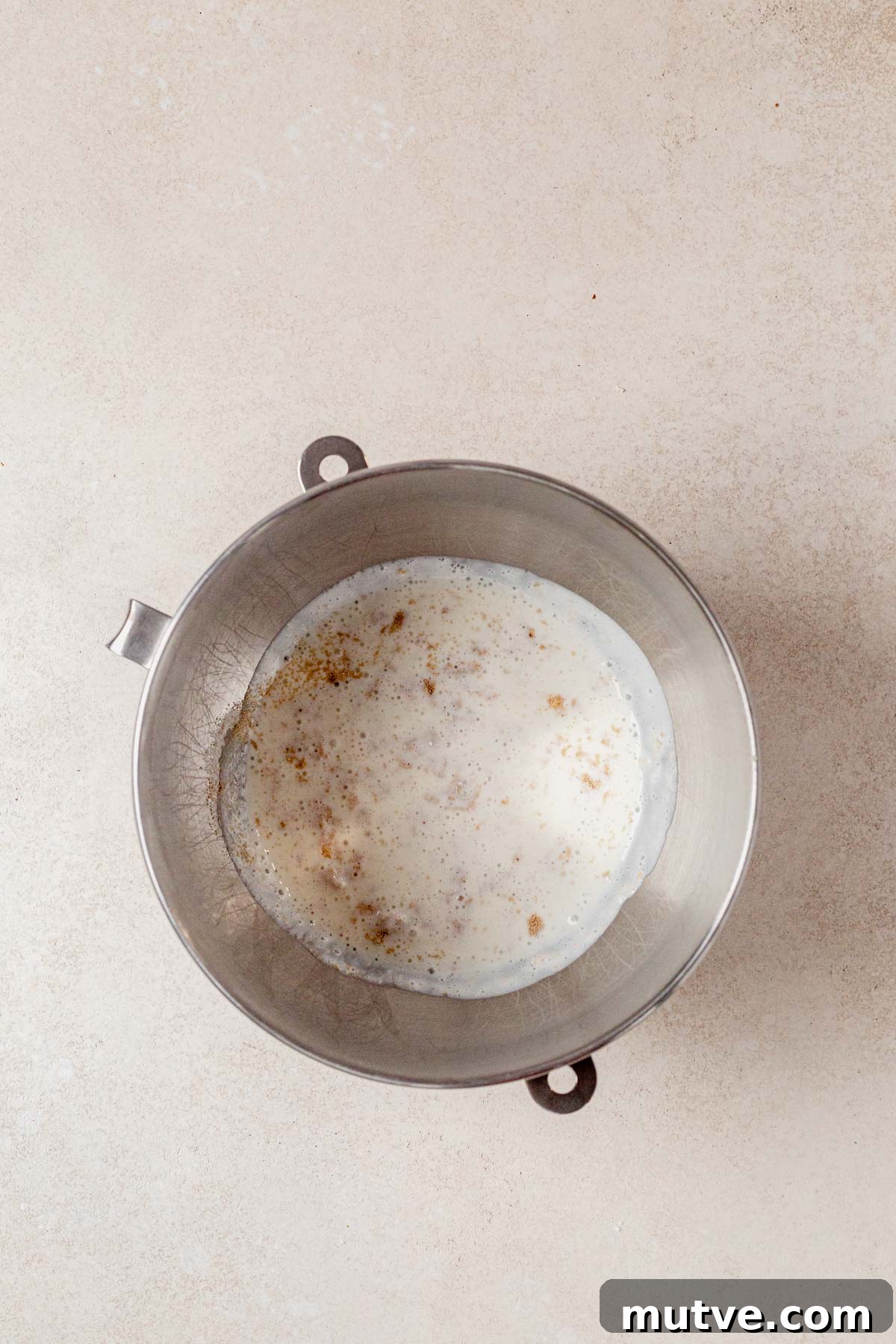 yeasting proofing in a bowl with milk and cottage cheese.