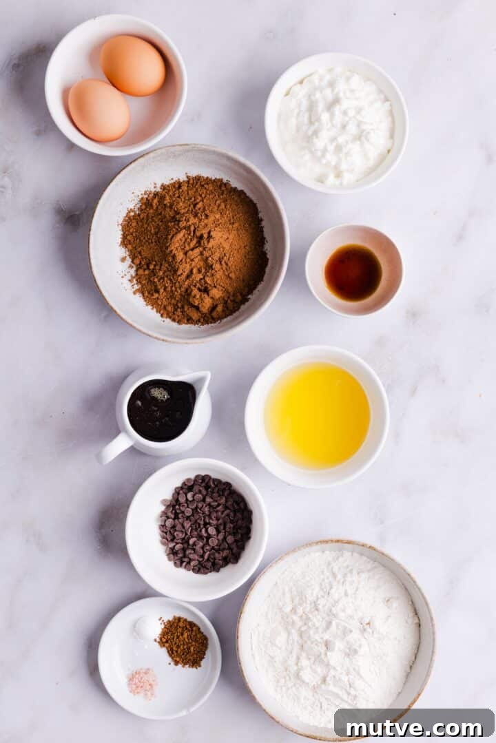Cottage Cheese Brownies Recipe: Moist, Protein-Packed Treat 4 Ingredients for cottage cheese brownies displayed in small bowls on a white kitchen counter