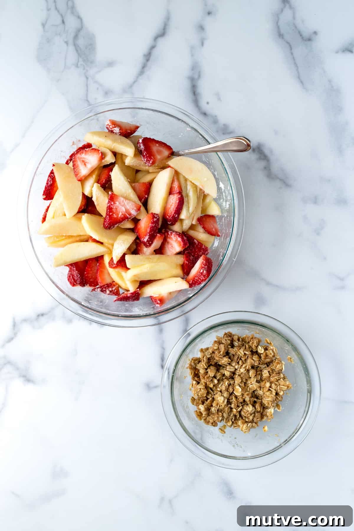 Warm Strawberry Apple Crisp Recipe with Cinnamon Oat Topping 5 process photo of sliced strawberries and apples.