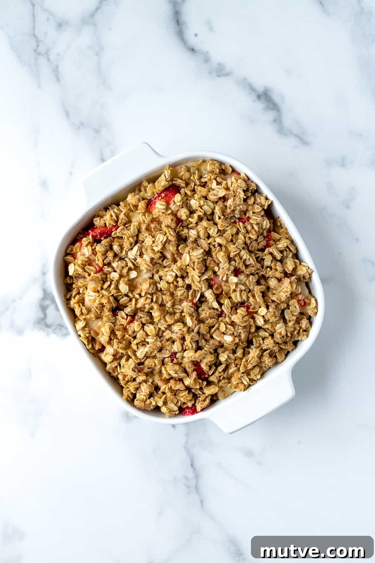 Warm Strawberry Apple Crisp Recipe with Cinnamon Oat Topping 7 Strawberry Apple Crisp in a white baking dish ready to bake.