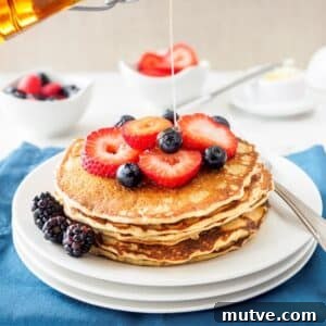 Fluffy Whole Wheat and Quinoa Flour Pancakes 5 Stack of whole wheat quinoa flour pancakes topped with berries.