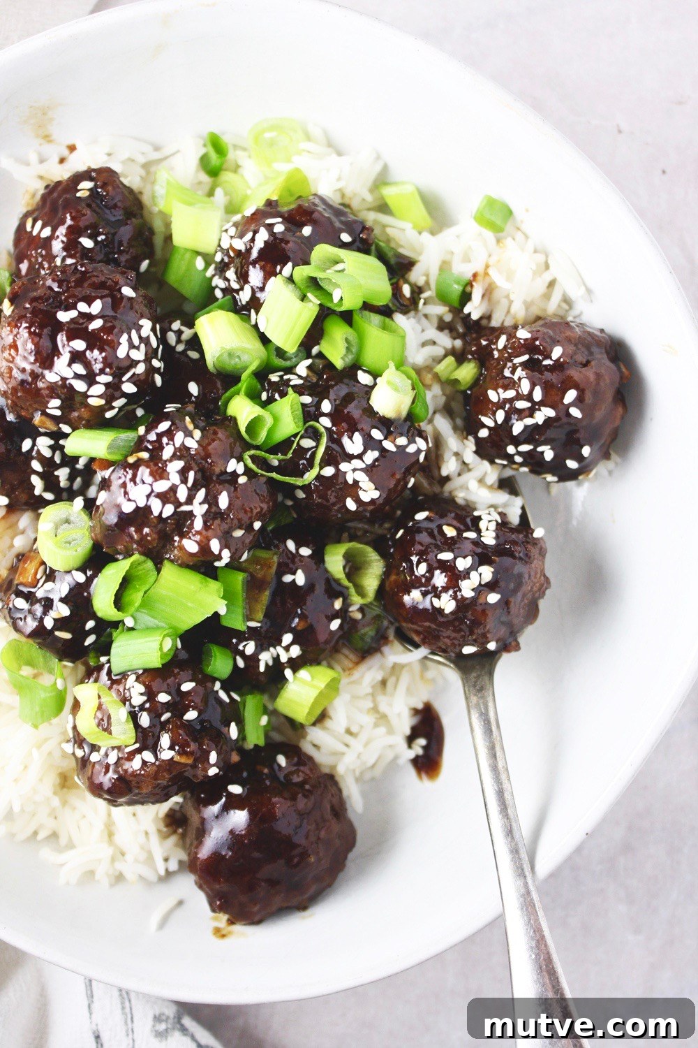 Mongolian Beef Meatballs - Just like the classic takeout dish, but in a fun new form: meatballs! Saucy, tender, and SO flavorful! Delicious served over rice! TheGarlicDiaries.com