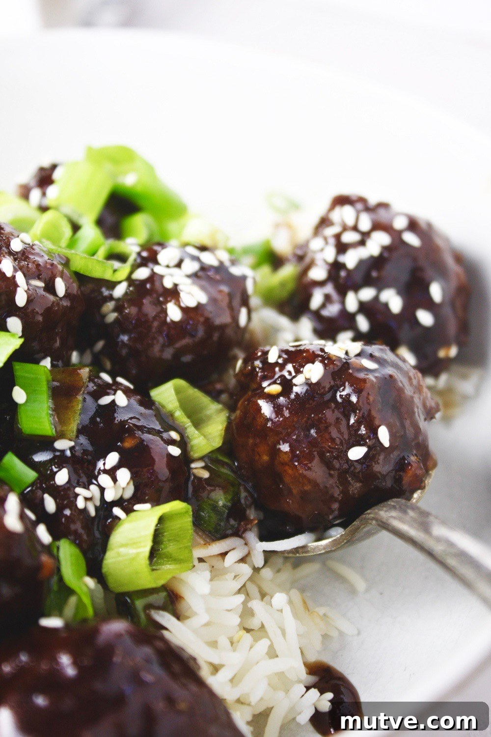 Mongolian Beef Meatballs - Just like the classic takeout dish, but in a fun new form: meatballs! Saucy, tender, and SO flavorful! Delicious served over rice! TheGarlicDiaries.com