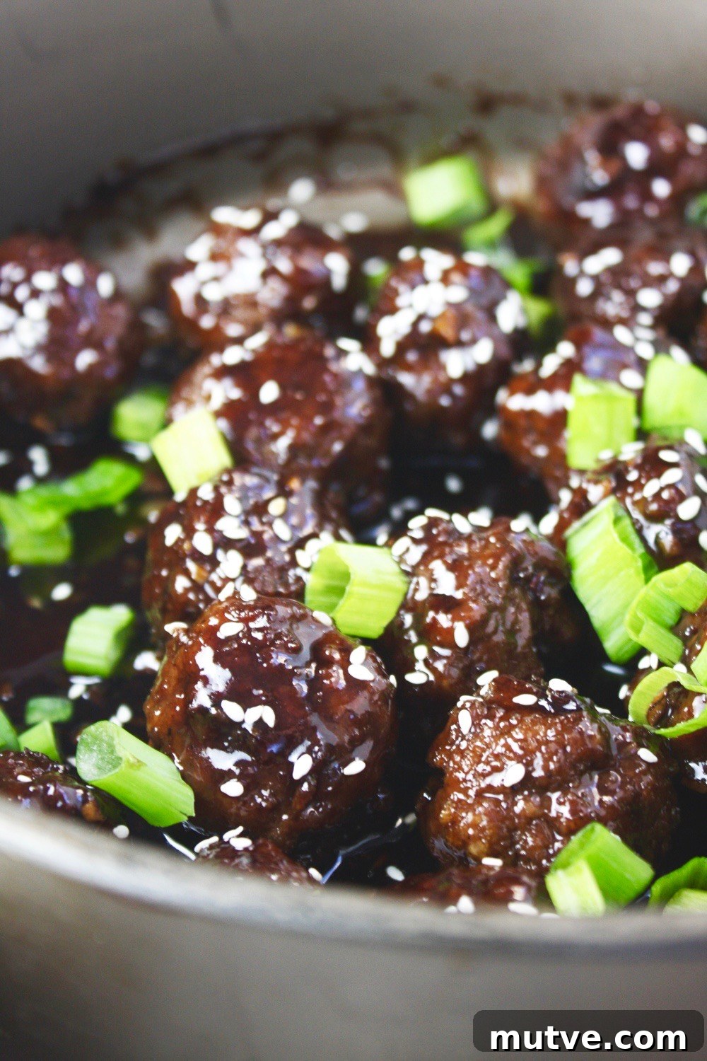 Mongolian Beef Meatballs - Just like the classic takeout dish, but in a fun new form: meatballs! Saucy, tender, and SO flavorful! Delicious served over rice! TheGarlicDiaries.com