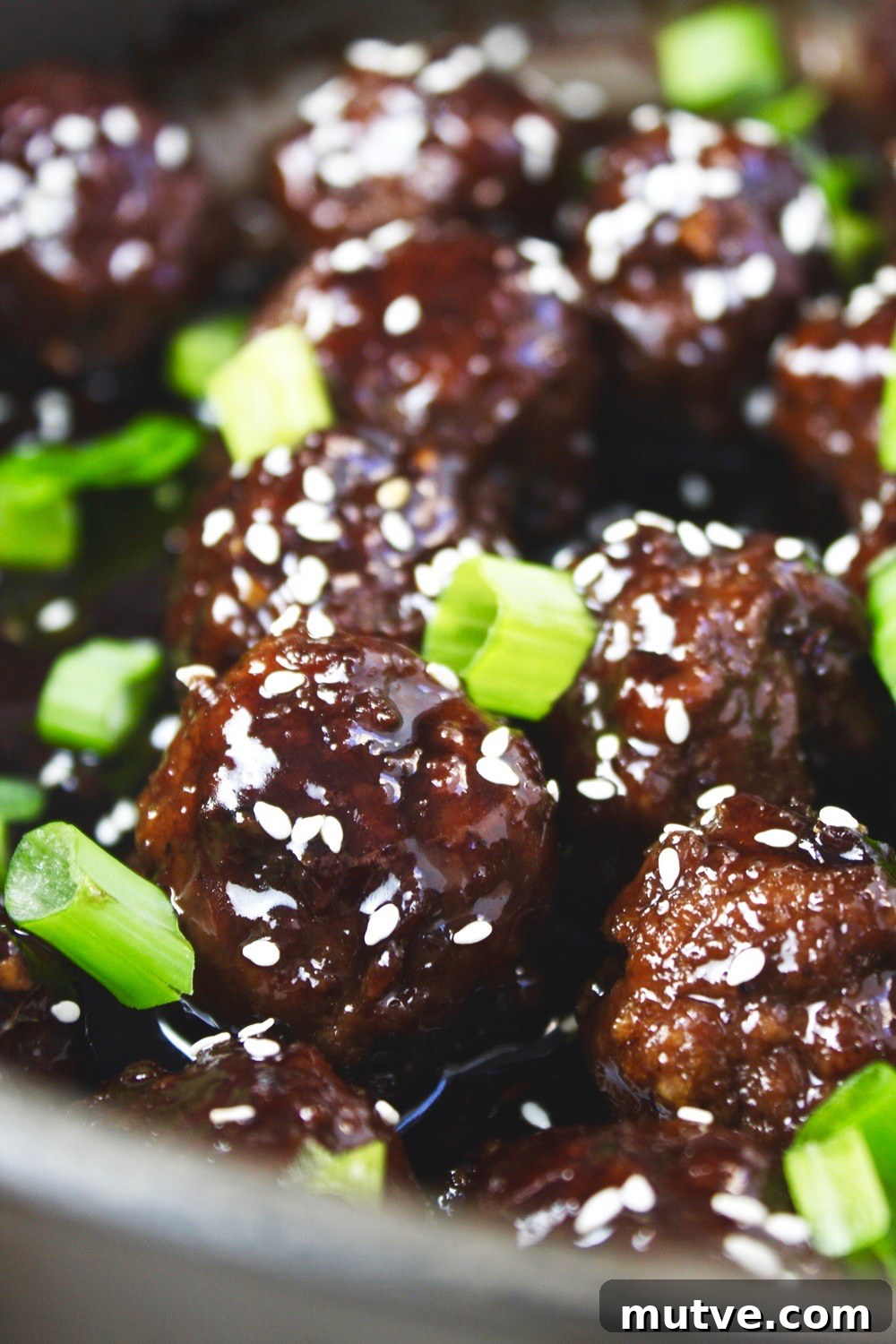 Mongolian Beef Meatballs - Just like the classic takeout dish, but in a fun new form: meatballs! Saucy, tender, and SO flavorful! Delicious served over rice! TheGarlicDiaries.com