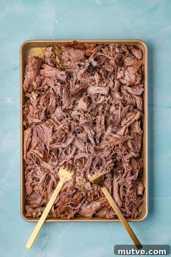 Slow Cooker Shredded Pork Tacos shredded on a baking sheet