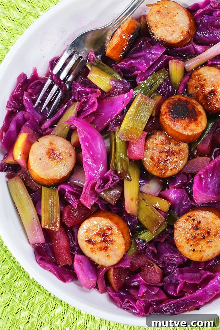 One-Pot Crispy Sausage with Sauteed Cabbage 2 Easy Homemade Sausage and Cabbage in White Bowl on Green Background