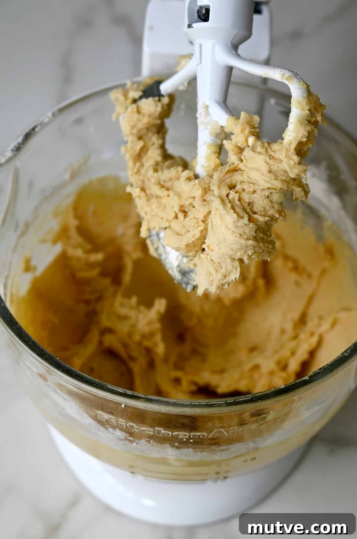 Blondie batter in a stand mixer with the paddle attachment.