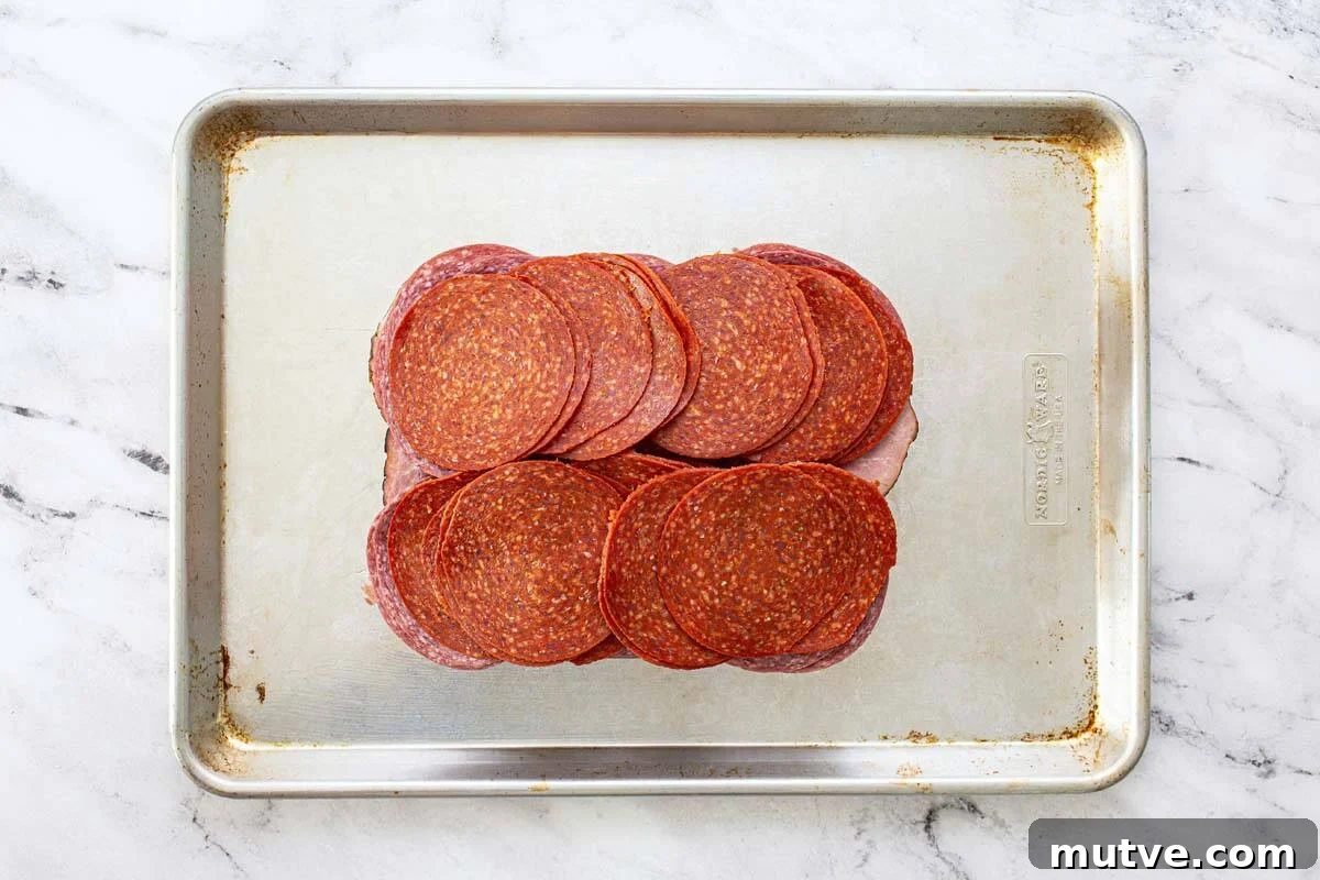 How to Make Italian Sliders with Mozzarella and Pepperoni 4 Ham, salami, and pepperoni on a slab of Hawaiian rolls.