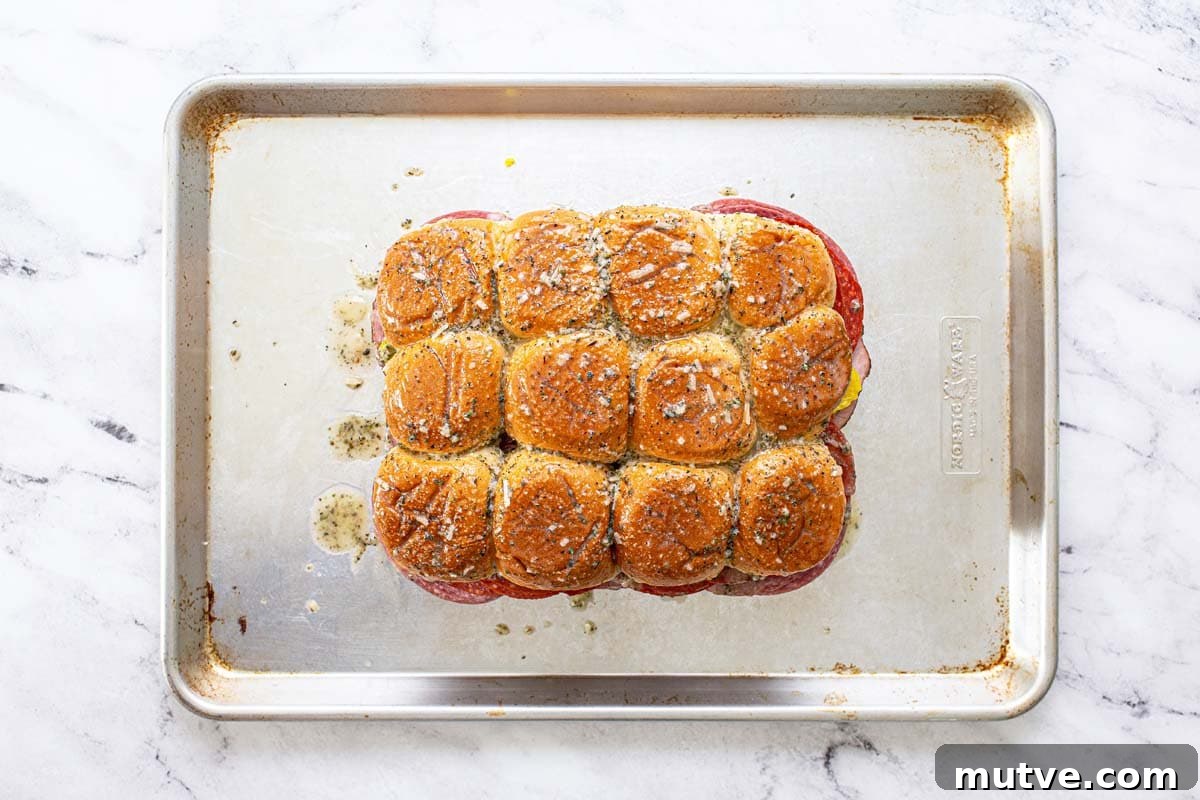 How to Make Italian Sliders with Mozzarella and Pepperoni 5 Italian sliders assembled and brushed with a Parmesan herb butter sauce.
