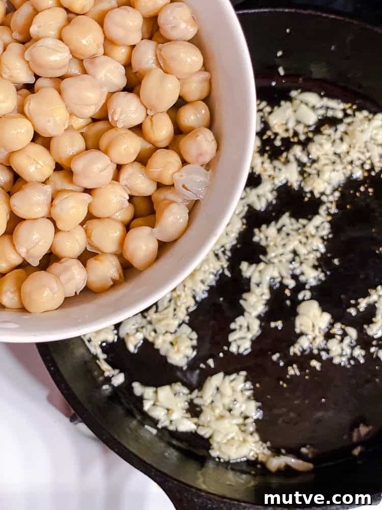 process shot showing adding chickpeas to pan