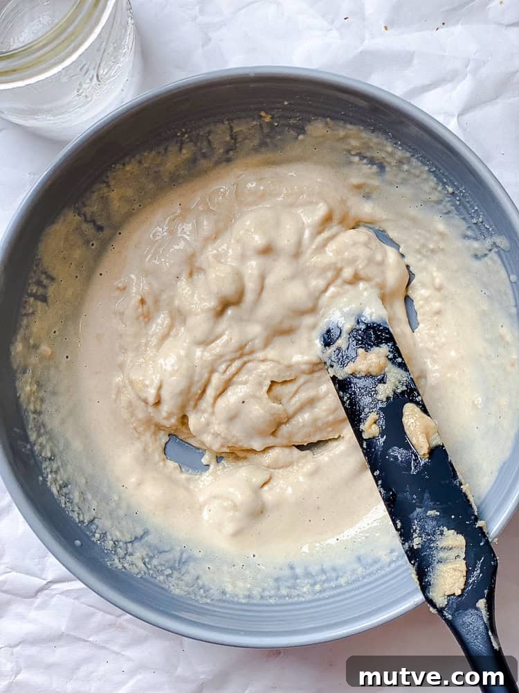 process shot showing mixing tahini mixture in bowl