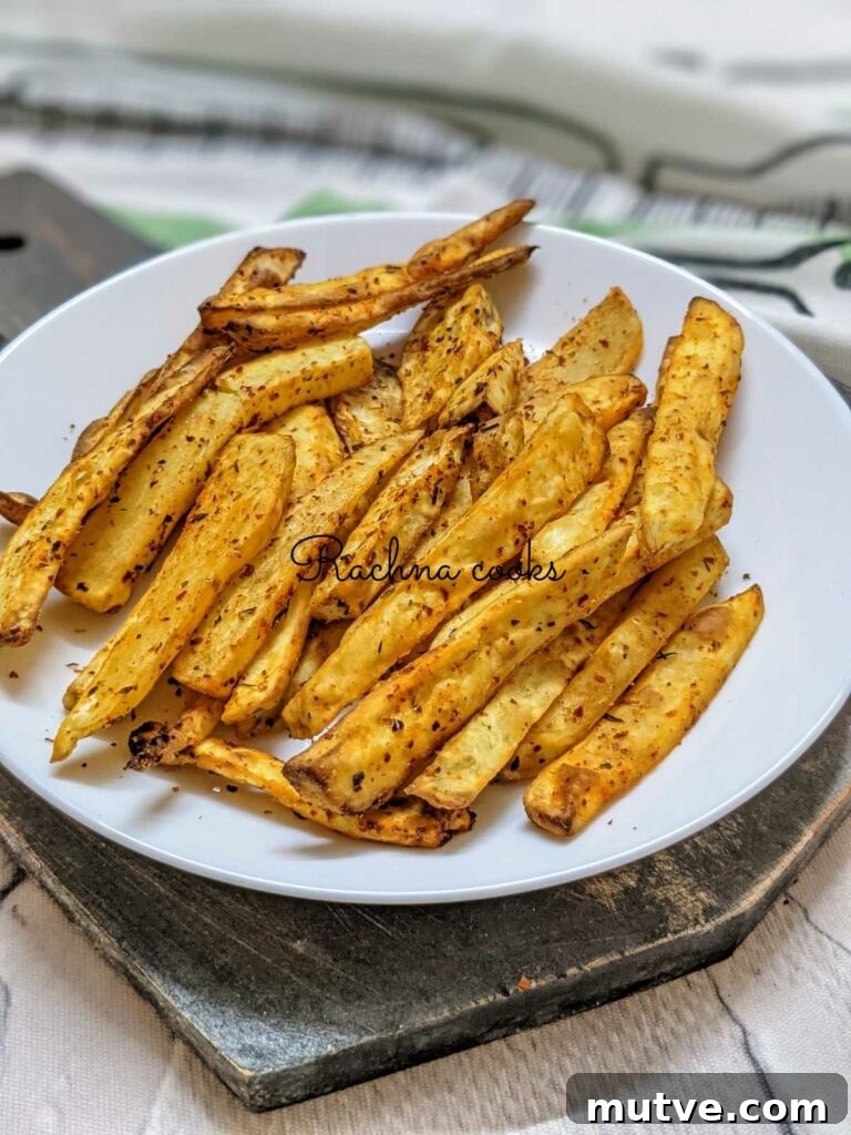 Crispy air fryer sweet potato fries on a white plate.