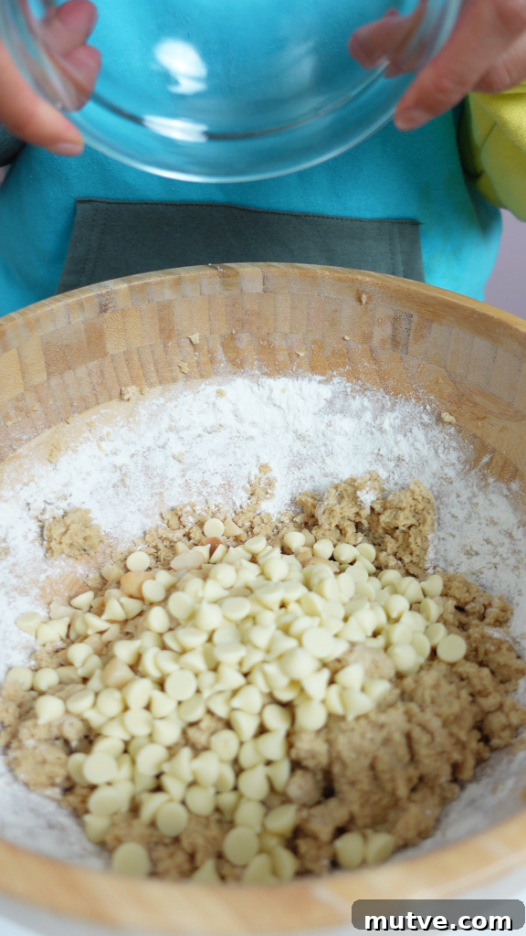 White Chocolate Macadamia Nut Cookies: Cookiemas Day 10 5 Baked white chocolate macadamia nut cookies on a tray