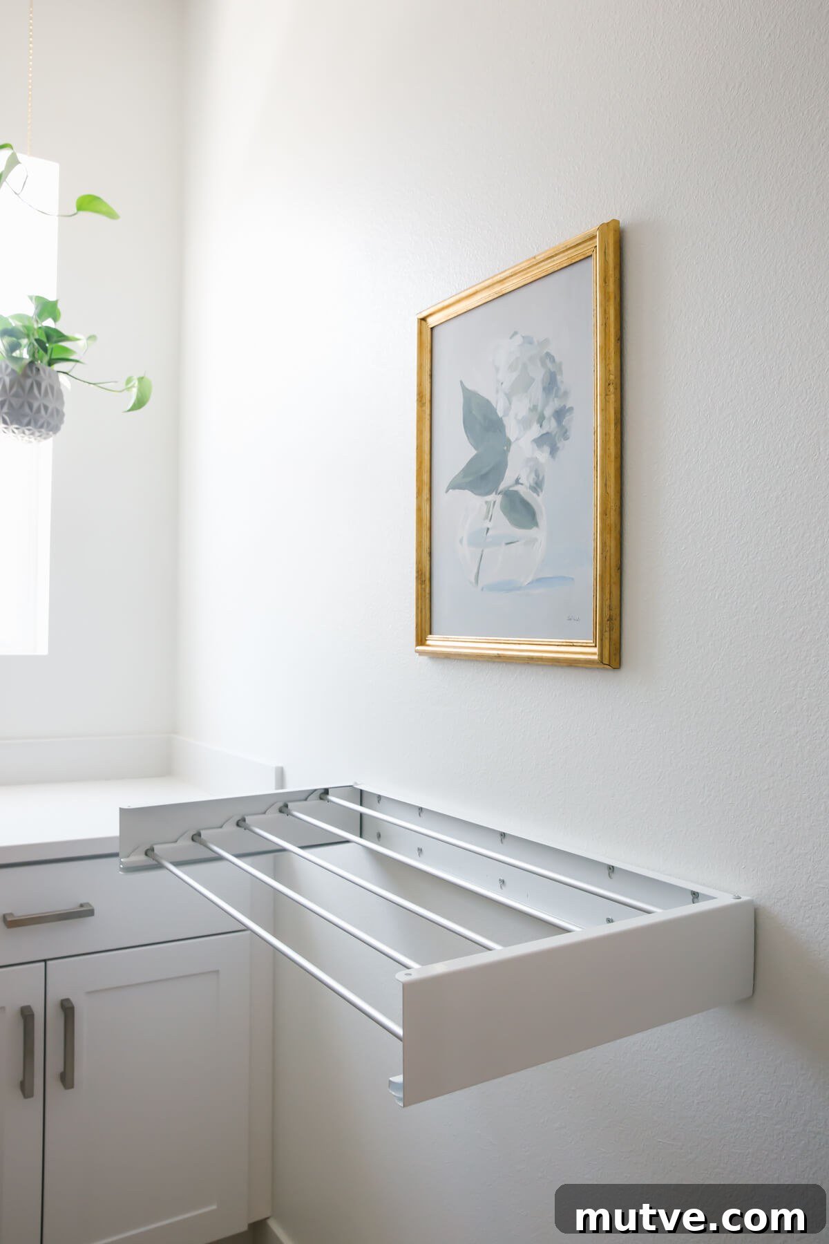 Wall drying rack in laundry room.