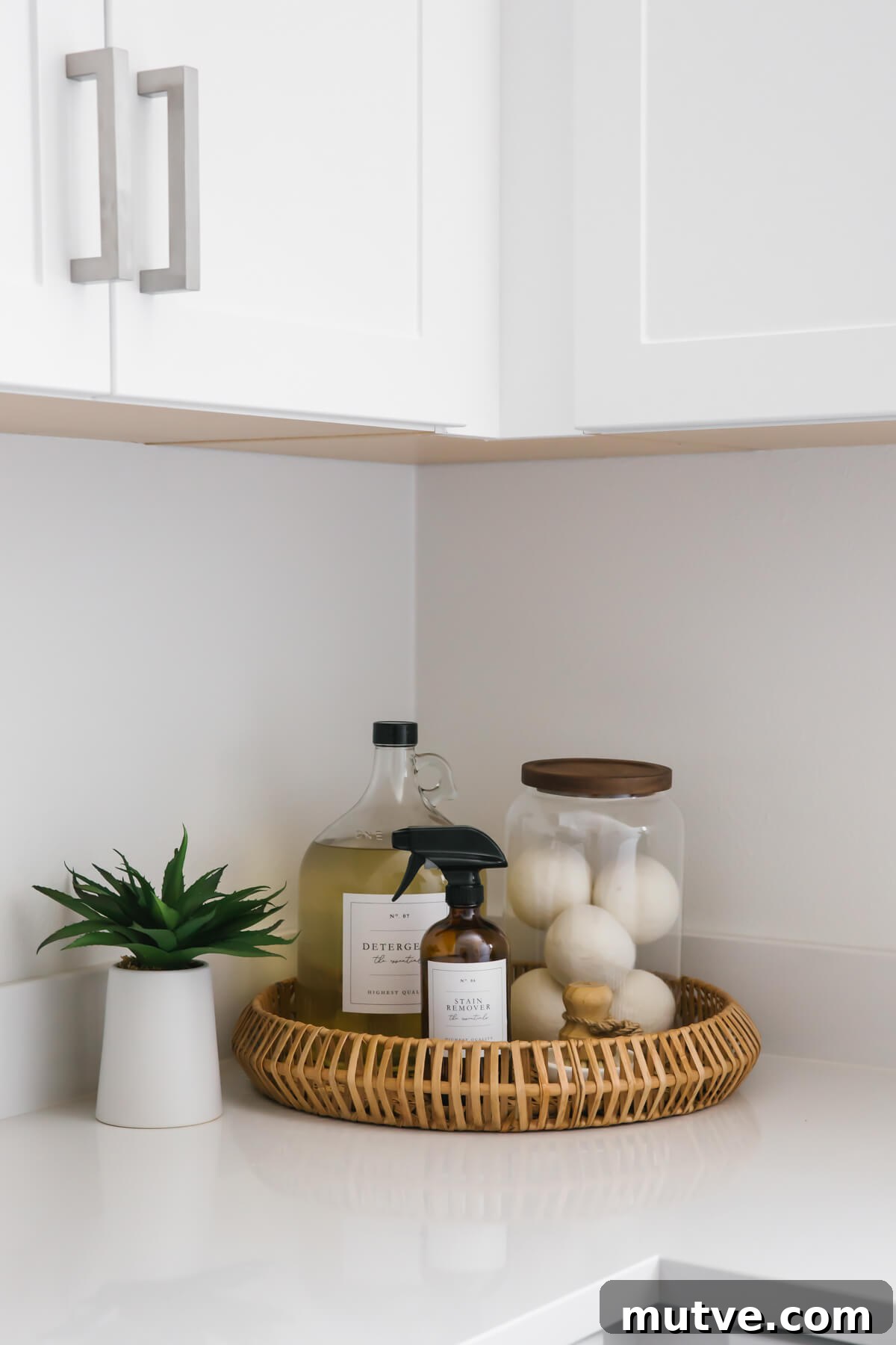 Cleaning materials and dryer balls in wicker basket in laundry room.