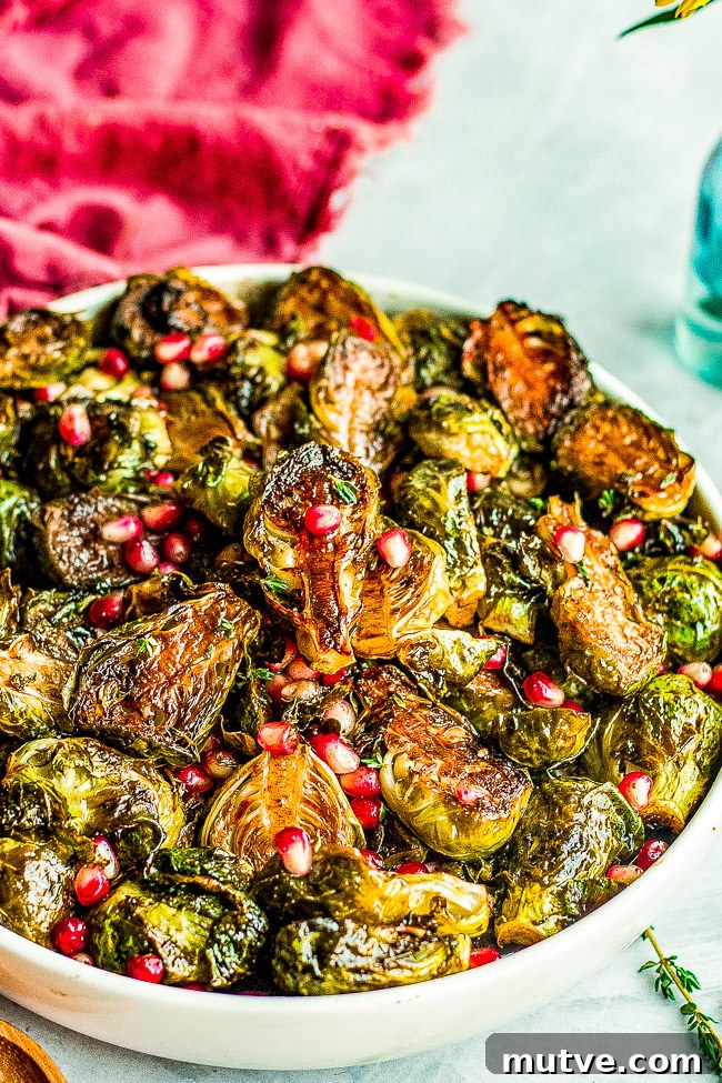 Balsamic Glazed Brussels Sprouts with Pomegranate Seeds 3 Balsamic Glazed Brussels Sprouts with Pomegranate Seeds in a white bowl.
