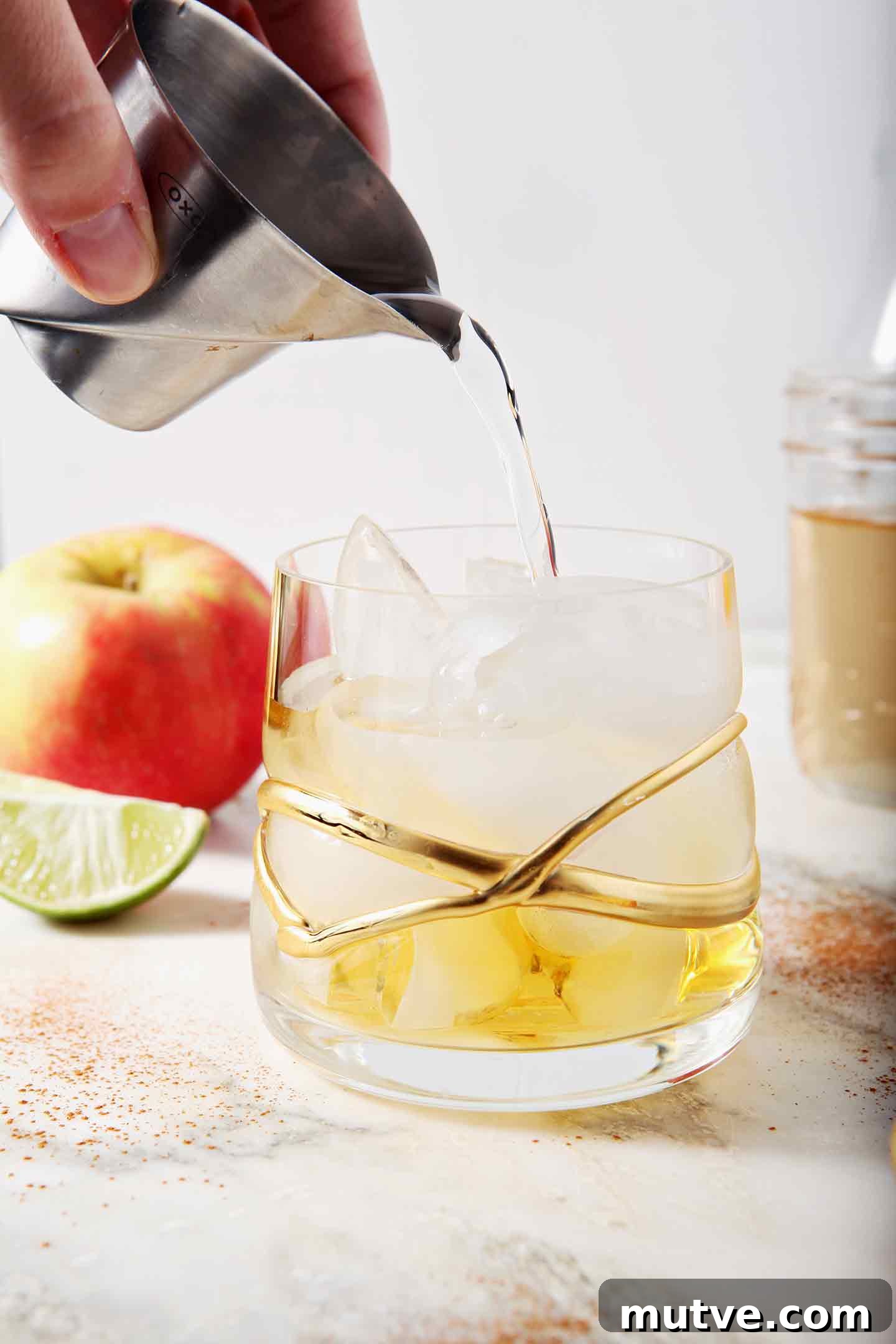 Apple Cider Moscow Mule Cocktail Recipe 5 Cinnamon simple syrup pours into a glass with apple cider
