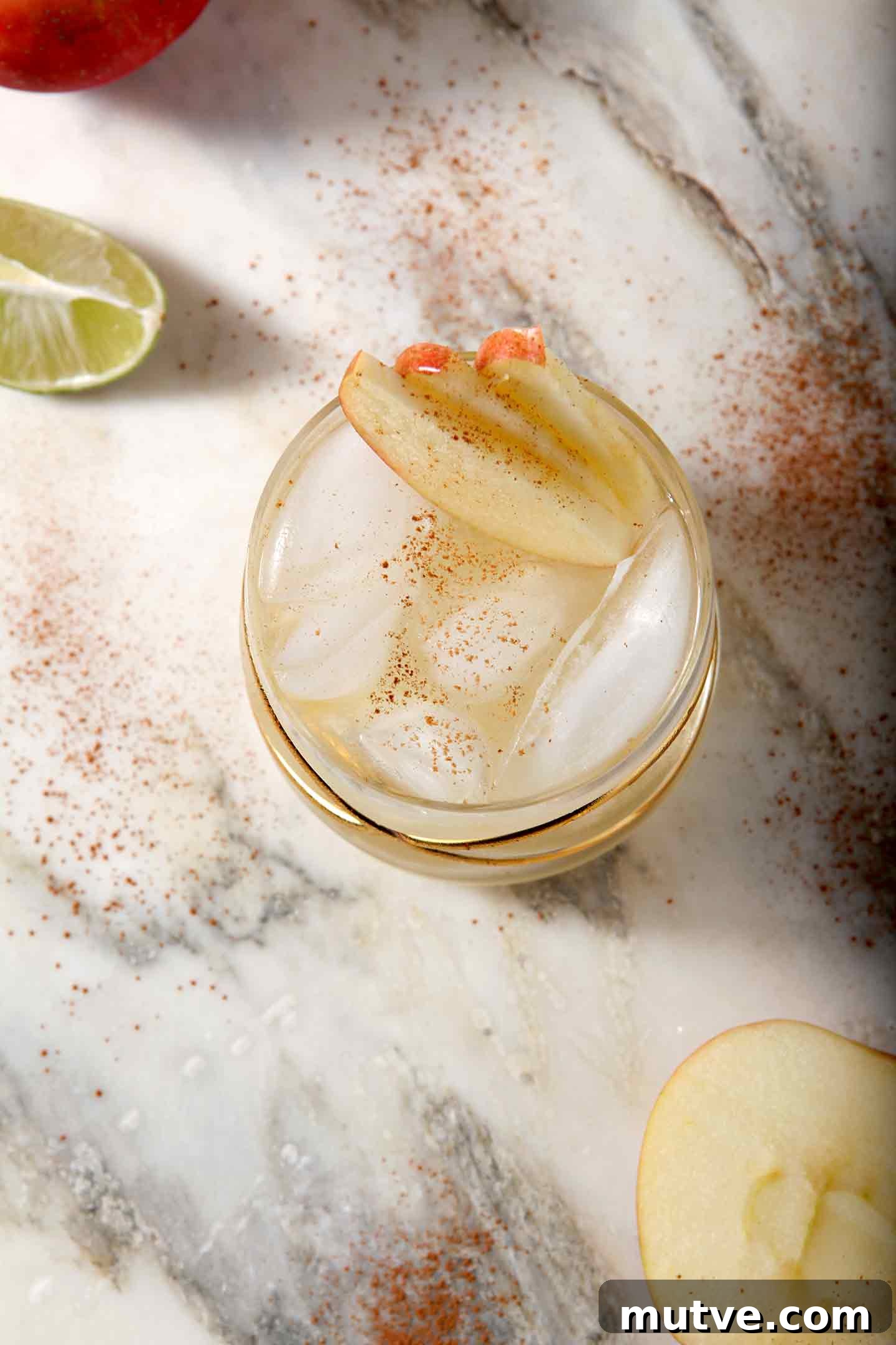 Apple Cider Moscow Mule Cocktail Recipe 8 Overhead image of an Apple Cider Moscow Mule, shown with apples and lime slices