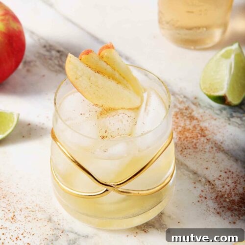 Apple Cider Moscow Mule Cocktail Recipe 10 A Apple Pie Moscow Mule sits on a marble background, surrounded by apples and lime slices
