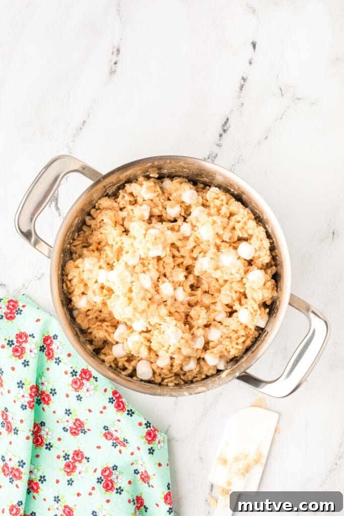 Browned Butter Rice Krispie Treats 11 Gooey rice crispy mixture with partially melted marshmallows stirred in, creating a soft and chewy texture.