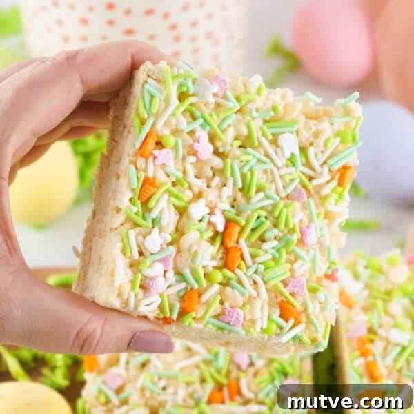 Browned Butter Rice Krispie Treats 14 hand holding Easter Rice Crispy Treats are the perfect treat for spring. This recipe can easily be made allergy-friendly for a goody everyone can enjoy.