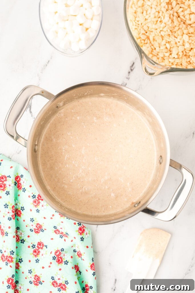 Browned Butter Rice Krispie Treats 7 Melted marshmallow mixture combined with browned butter in a pot, ready for crispy rice cereal to be stirred in.