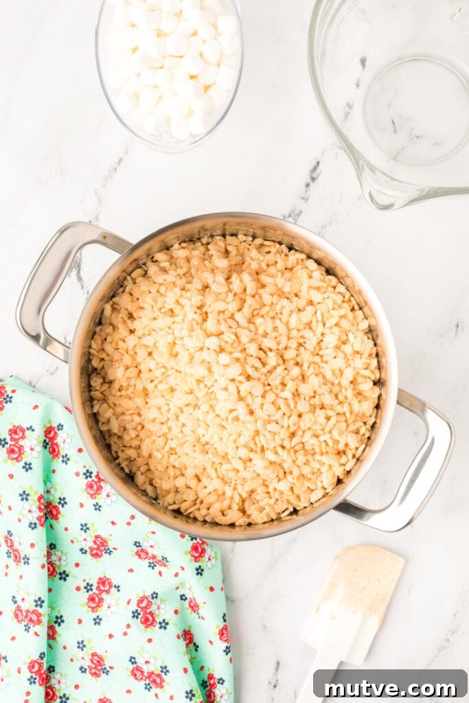 Browned Butter Rice Krispie Treats 8 Crispy rice cereal poured into the pot of melted marshmallow and browned butter mixture.