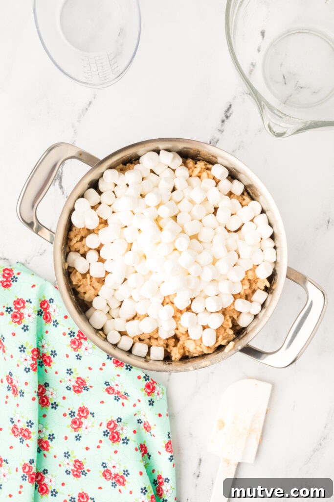 Browned Butter Rice Krispie Treats 10 Reserved mini marshmallows added to the pot of cereal mixture for extra gooey pockets in the Browned Butter Rice Crispy Treats.