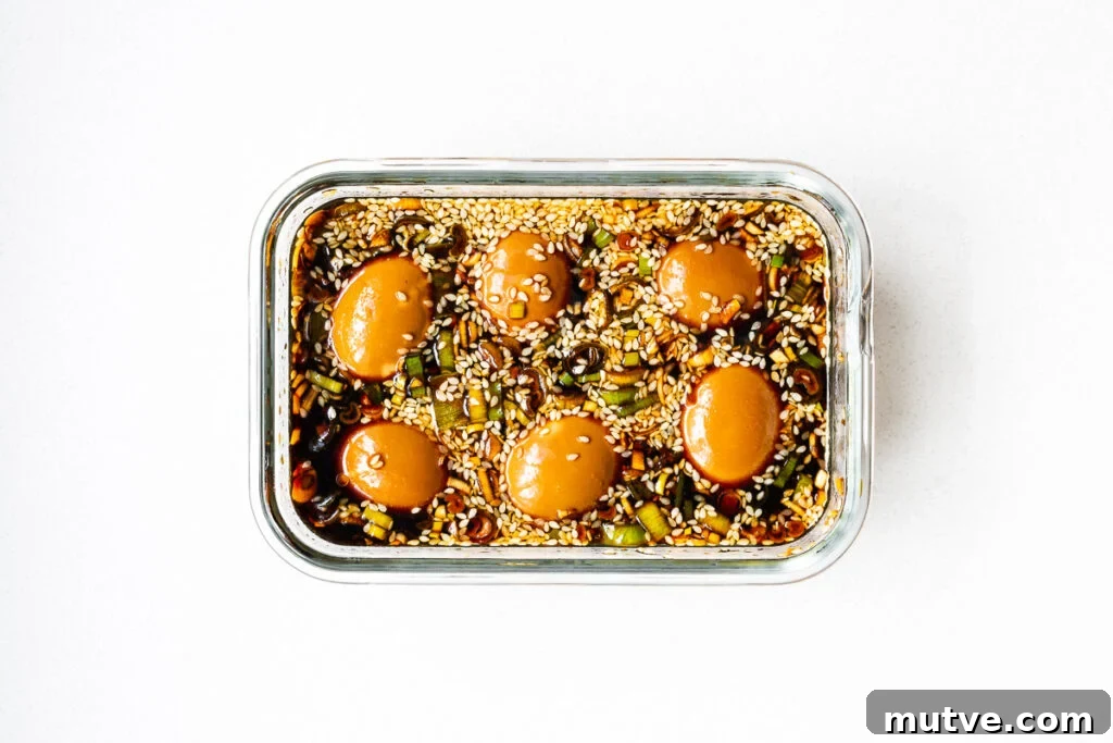 Mayak Eggs Recipe: Korean Soy-Marinated Ramen Eggs 11 Soy-marinated eggs in a glass container.