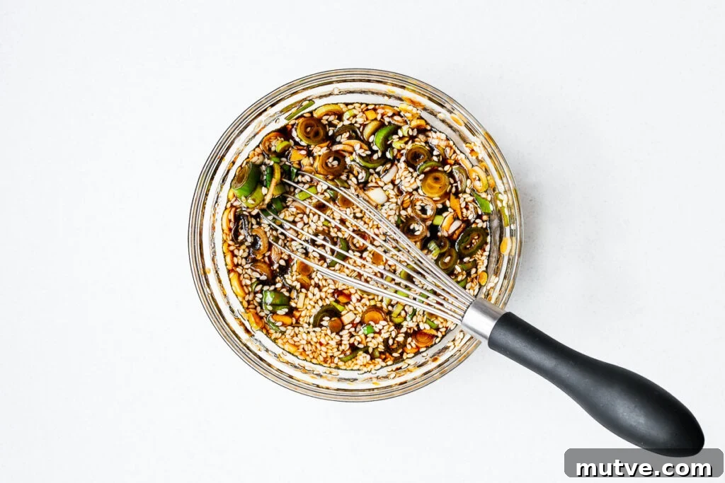 Mayak Eggs Recipe: Korean Soy-Marinated Ramen Eggs 9 A bowl of Korean egg marinade with a whisk.