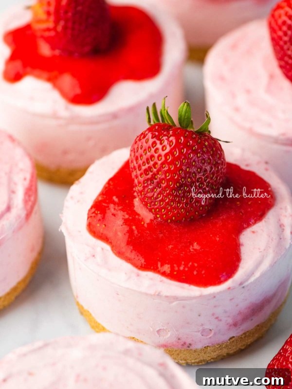 Moist Single-Layer Chocolate Cake Recipe 11 Individual no-bake strawberry cheesecakes topped with strawberry glaze and a fresh strawberry on a parchment paper-lined baking sheet.