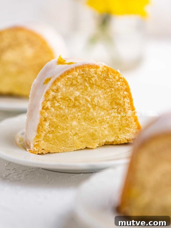 Moist Single-Layer Chocolate Cake Recipe 12 Small lemon cream cheese pound cake slice on a small dessert plate on white background.