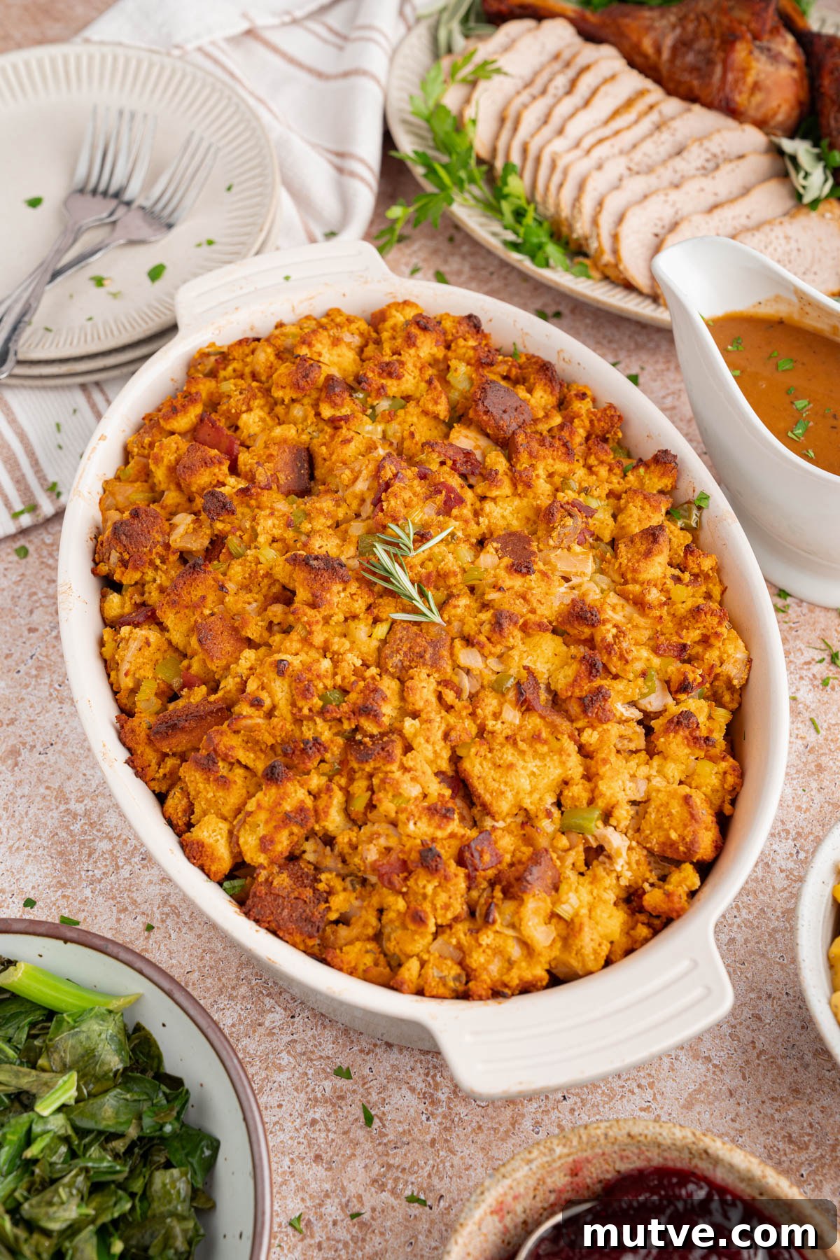 Classic Southern Cornbread Dressing 6 Baked cornbread dressing in a casserole dish on a countertop for serving.