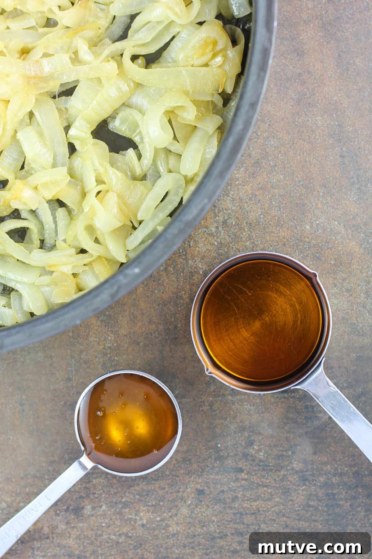 measuring cups with honey and bourbon