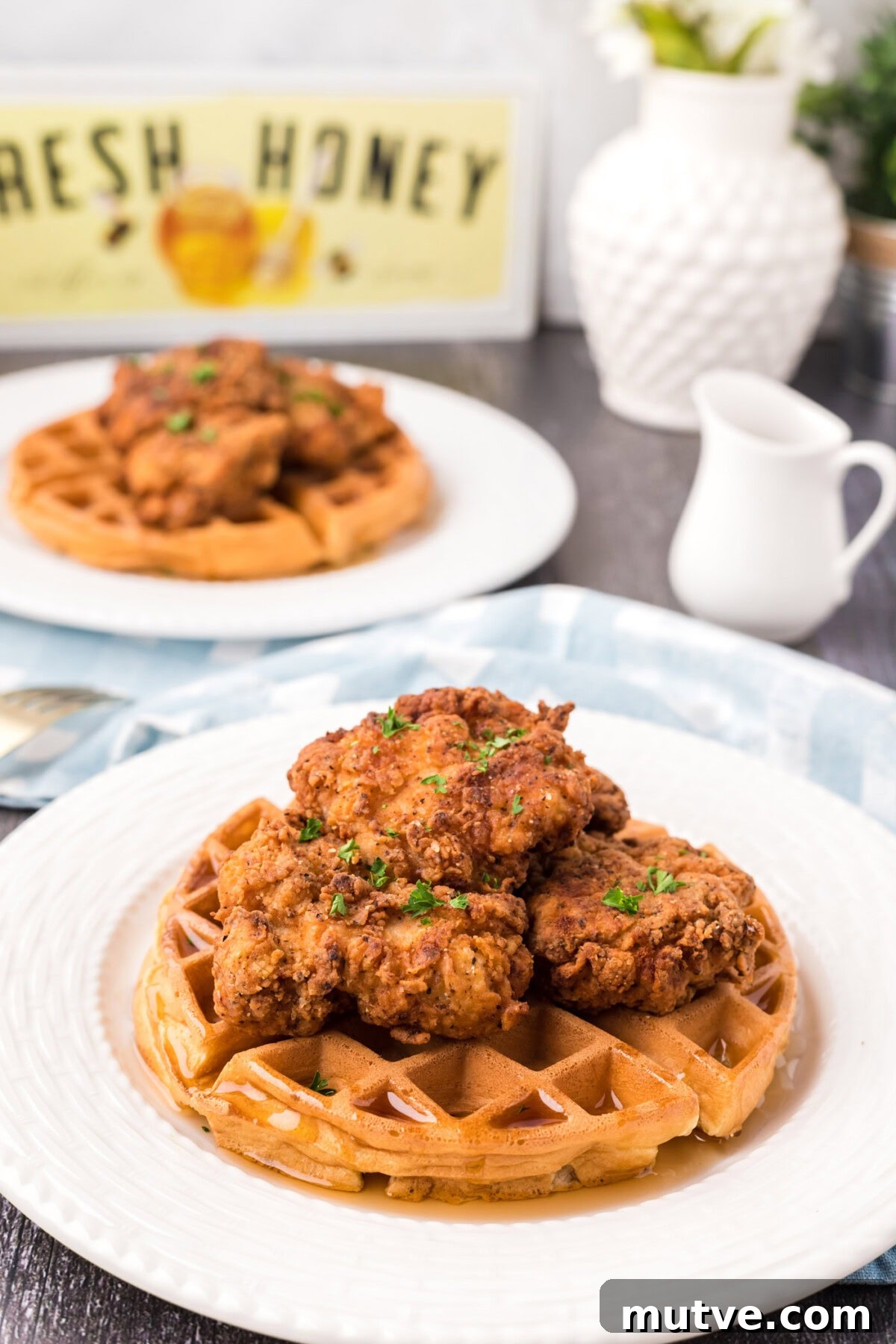 Crispy Chicken and Waffles Recipe with Maple Syrup 2 Two plates of Chicken and Waffles