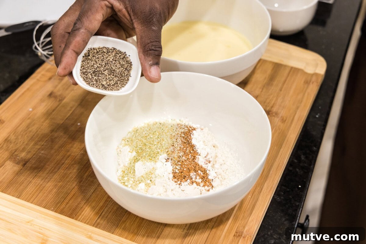 Crispy Chicken and Waffles Recipe with Maple Syrup 6 adding pepper to flour mixture